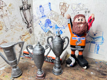 Load image into Gallery viewer, Sheffield Steelers cartoon character tansey 6 with medals / celebrating with removable trophies and Grand Slam base
