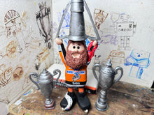 Load image into Gallery viewer, Sheffield Steelers cartoon character tansey 6 with medals / celebrating with removable trophies and Grand Slam base
