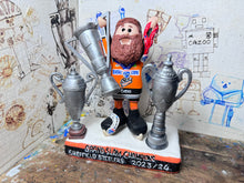 Load image into Gallery viewer, Sheffield Steelers cartoon character tansey 6 with medals / celebrating with removable trophies and Grand Slam base
