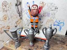 Load image into Gallery viewer, Sheffield Steelers cartoon character tansey 6 with medals / celebrating with removable trophies and Grand Slam base
