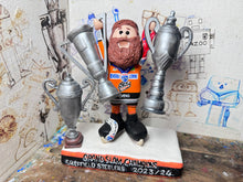 Load image into Gallery viewer, Sheffield Steelers cartoon character tansey 6 with medals / celebrating with removable trophies and Grand Slam base
