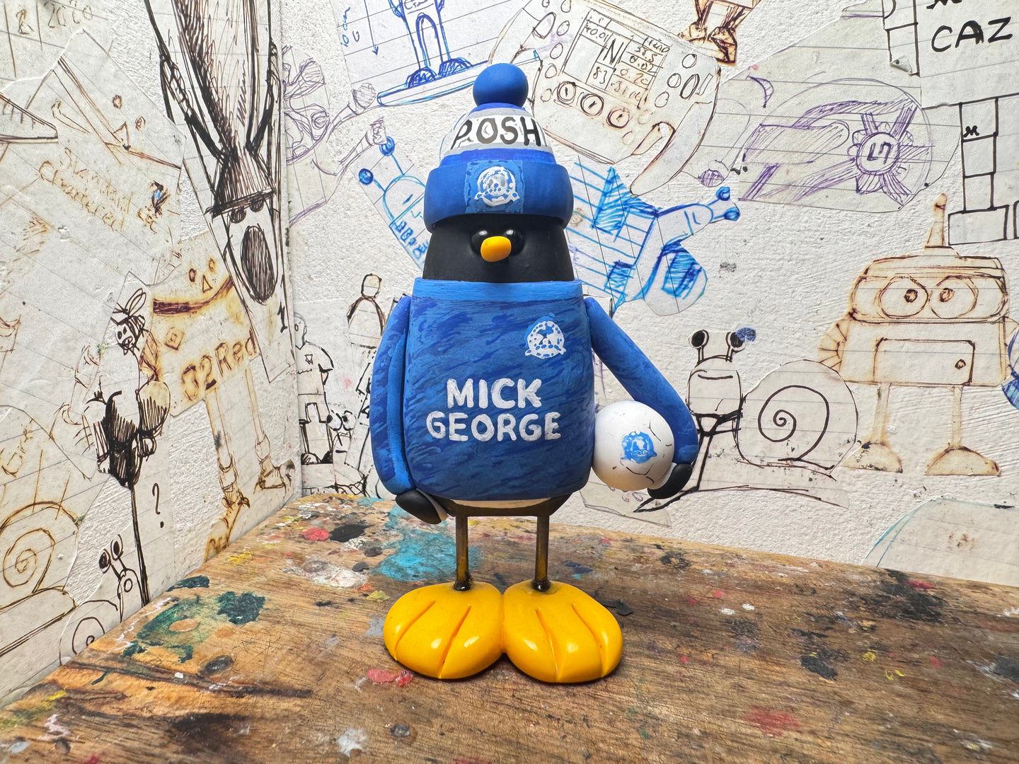 Peterborough United goalkeeper penguin 2025/2026 with football and woolly hat (blue)