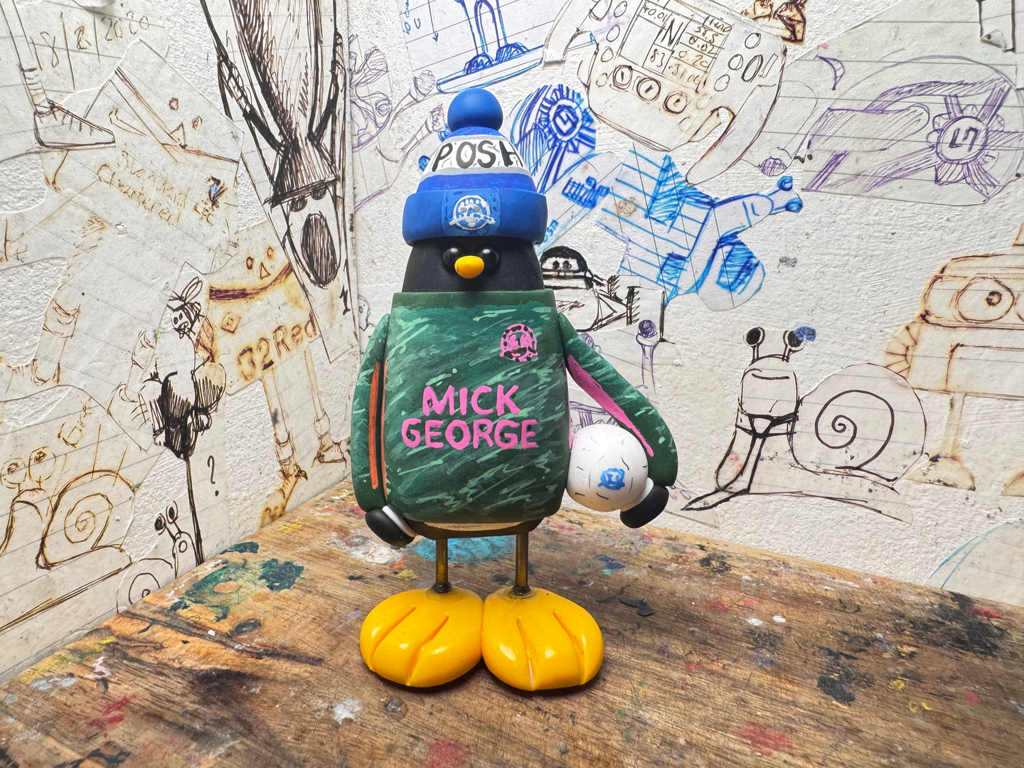 Peterborough United goalkeeper penguin 2025/2026 with football and woolly hat (green)