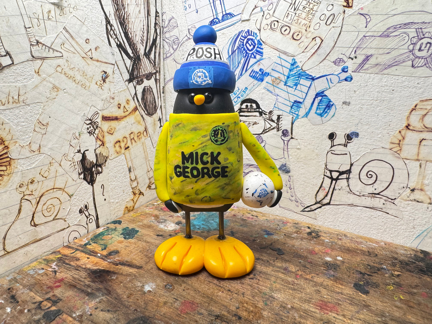 Peterborough United goalkeeper penguin 2025/2026 with football and woolly hat (yellow)